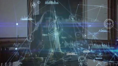 Woman at kitchen counter typing, causing animated HUD graphs overlaying laptop Stock Footage 333368168