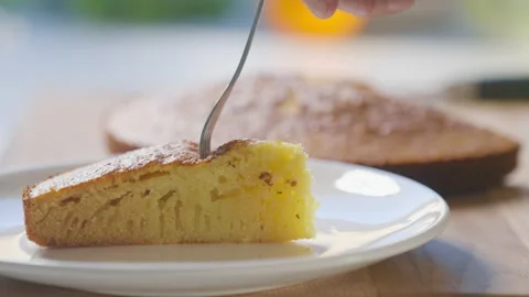 Woman in the kitchen cutting a cake Stock Footage 200716293