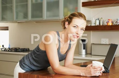 Woman In Kitchen Looking At Camera