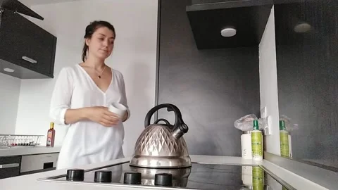 Woman in kitchen making breakfast and coffee Stock Footage
