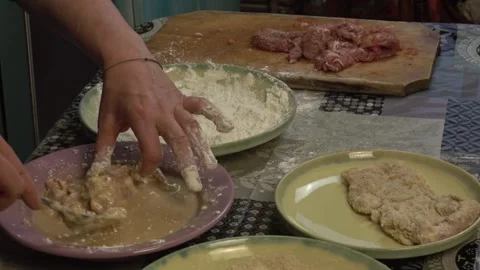 Woman in the kitchen preparing schnitzels Stock Footage 334522329