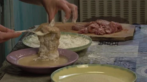 Woman in the kitchen preparing schnitzels 스톡 동영상 334522346