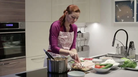 Woman in the kitchen preparing stuffed cabbage Stock Footage 58761093