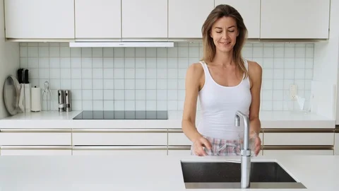 Woman In Kitchen Using Tap Stock Footage 117065794