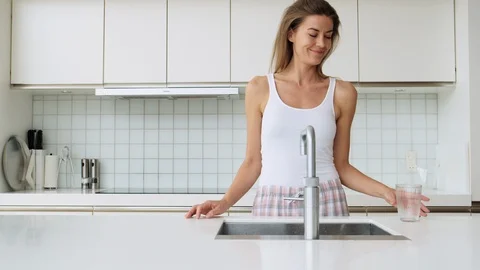 Woman In Kitchen Using Tap Stock Footage 117065854
