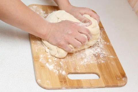 Woman kneading dough, close-up photo Stock Photos