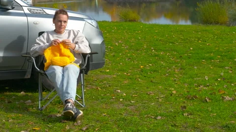 Woman knitting while camping in nature. Stock Footage 330687351
