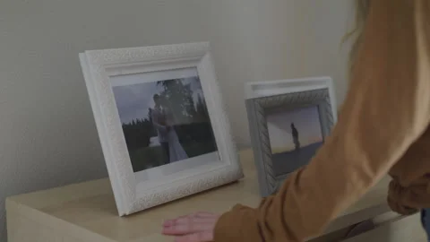 Woman Knocks Frames Off of Dresser in Rage 스톡 동영상 219556967