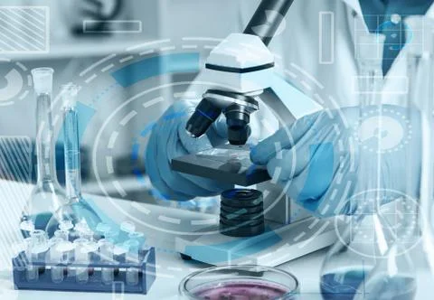 Woman in a laboratory microscope with microscope slide in hand.toned image. Stock Photos