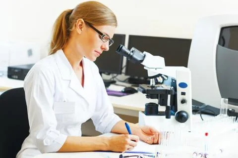 Woman in a laboratory working with samples. Stock Photos