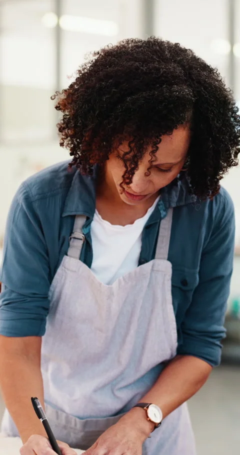 Woman, laptop and documents at workshop for pottery with typing, writing and Stock Footage 333394232