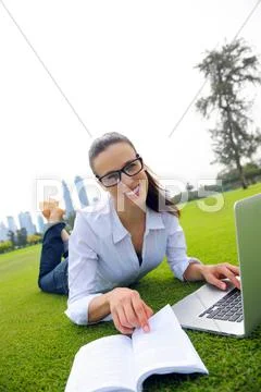 Woman with laptop in park Stock Photos