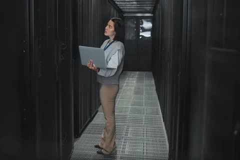 Woman with laptop, server room and information technology, technician and Stock Photos