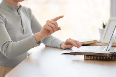 Woman with laptop using virtual screen at table in office, closeup. Customer  Stock Photos