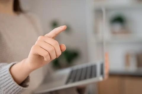 Woman with laptop using virtual screen at home, closeup. Customer experience  Stock Photos