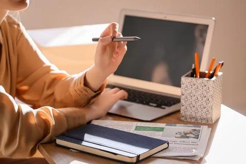 Woman with laptop using virtual screen at table in office, closeup. Customer  Stock Photos