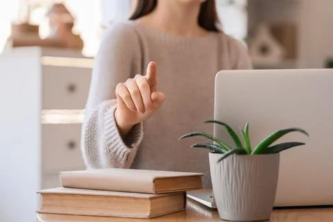 Woman with laptop using virtual screen at home, closeup. Customer experience  Stock Photos