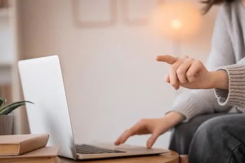 Woman with laptop using virtual screen at home, closeup. Customer experience  Foto stock