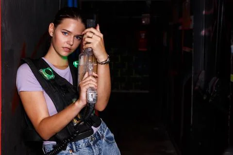 Woman with laser guns took aim and posing during laser tag game Stock Photos