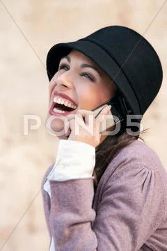 A Woman Laughing On A Mobile Phone