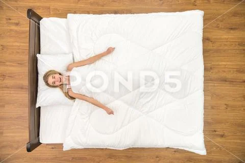 The woman lay on the bed and gesture. View from above Stock Photos