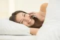 The woman lay on the bed and phone Photo