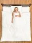 The woman lay on the bed and smile. View from above Photo