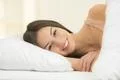 The woman lay on the bed and smile Photo