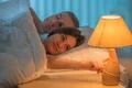 The woman lay on the bed with man. Evening night time Photo
