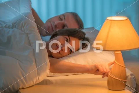The woman lay on the bed with man. Evening night time Stock Photos