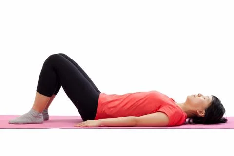 Woman laying down for exercising Stock Photos