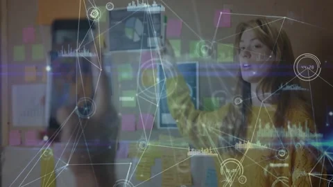 Woman lead pointing at notes wall; peer scanning phone causing AR nodes marking Stock Footage 333900171