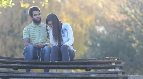 Woman leaning head on man's shoulder while they listening to music Stock Footage 59555813