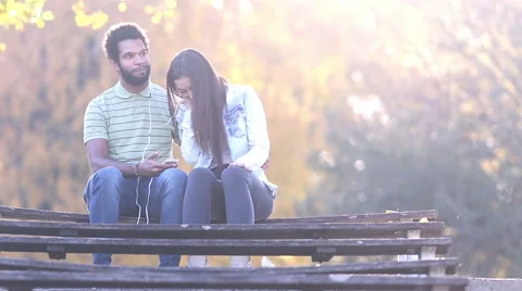 Woman leaning head on man's shoulder while they listening to music Stock Footage 59555819