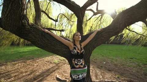 Woman leaning on tree Stock Footage 64817843