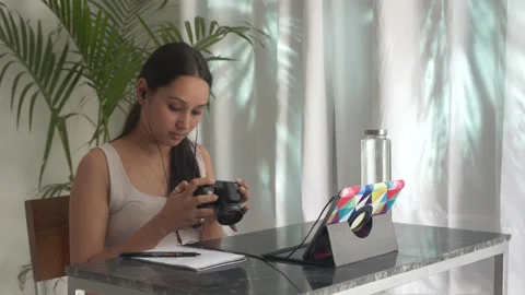 Woman is learning how to use camera through online photography learning lessons. Stock Footage 148522123