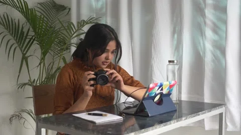 Woman is learning how to use camera through online photography learning lesson. Video stock 150778568
