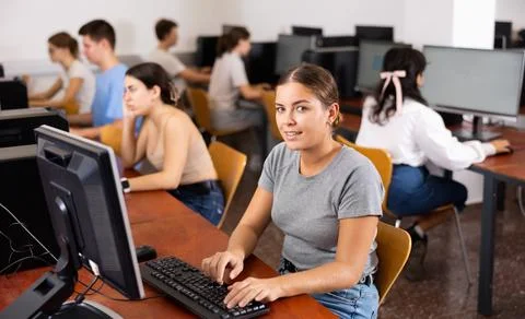 Woman learning to use software in computer class Stock Photos