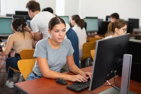 Woman learning to use software in computer class Stock Photos