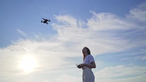 A woman learns to control a drone. Training to fly on a quadcopter in a safe Stock Footage 139890720
