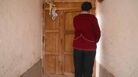 Woman leaving through wooden door Stock Footage