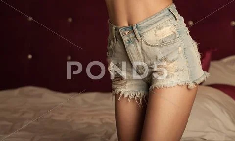 Woman legs in jeans shorts Stock Photos