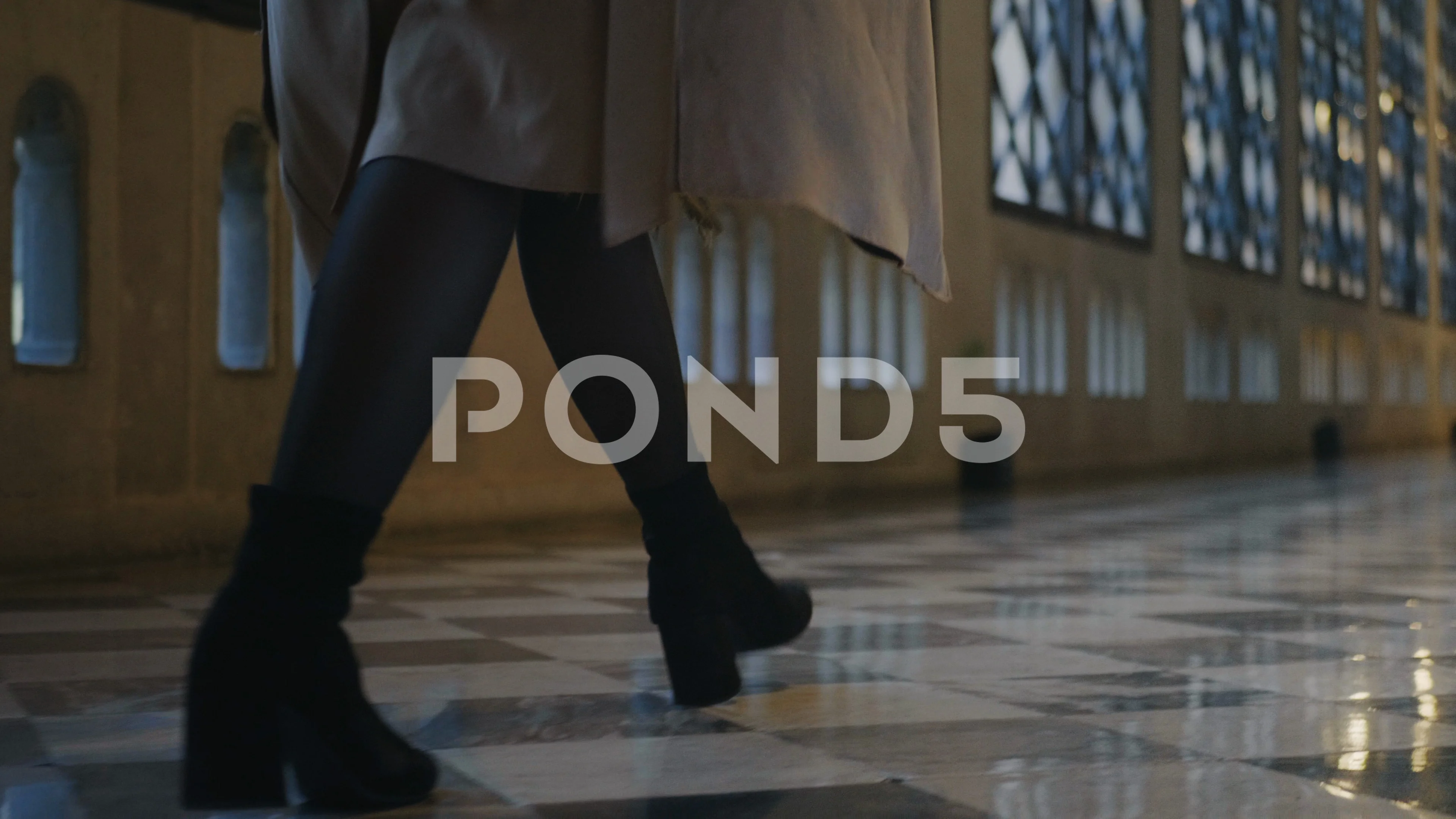 Woman legs walking in hall. Businesswoman on high heels walking in building