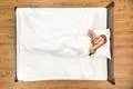 The woman lie on the bed. View from above Photo