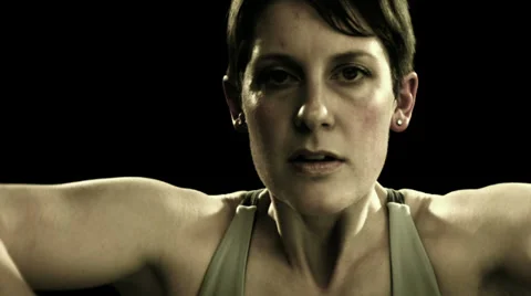 Woman lifting dumbbell weights while staring at camera Video stock 33831318