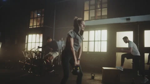 Woman lifting kettelbell from floor 스톡 동영상 236190836