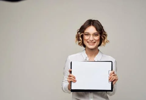 Woman on light background with document folder white shirt glasses mockup Stock Photos