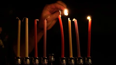 Woman lighting hanukkah candles Stock Footage