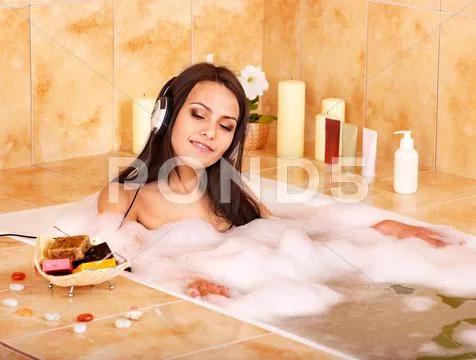 Woman listening to music in bath Stock Photos