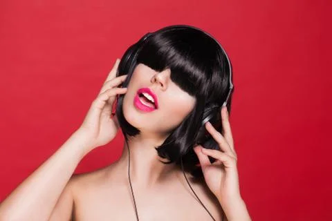 Woman listening to music on headphones enjoying a dance. Dj female Stock Photos